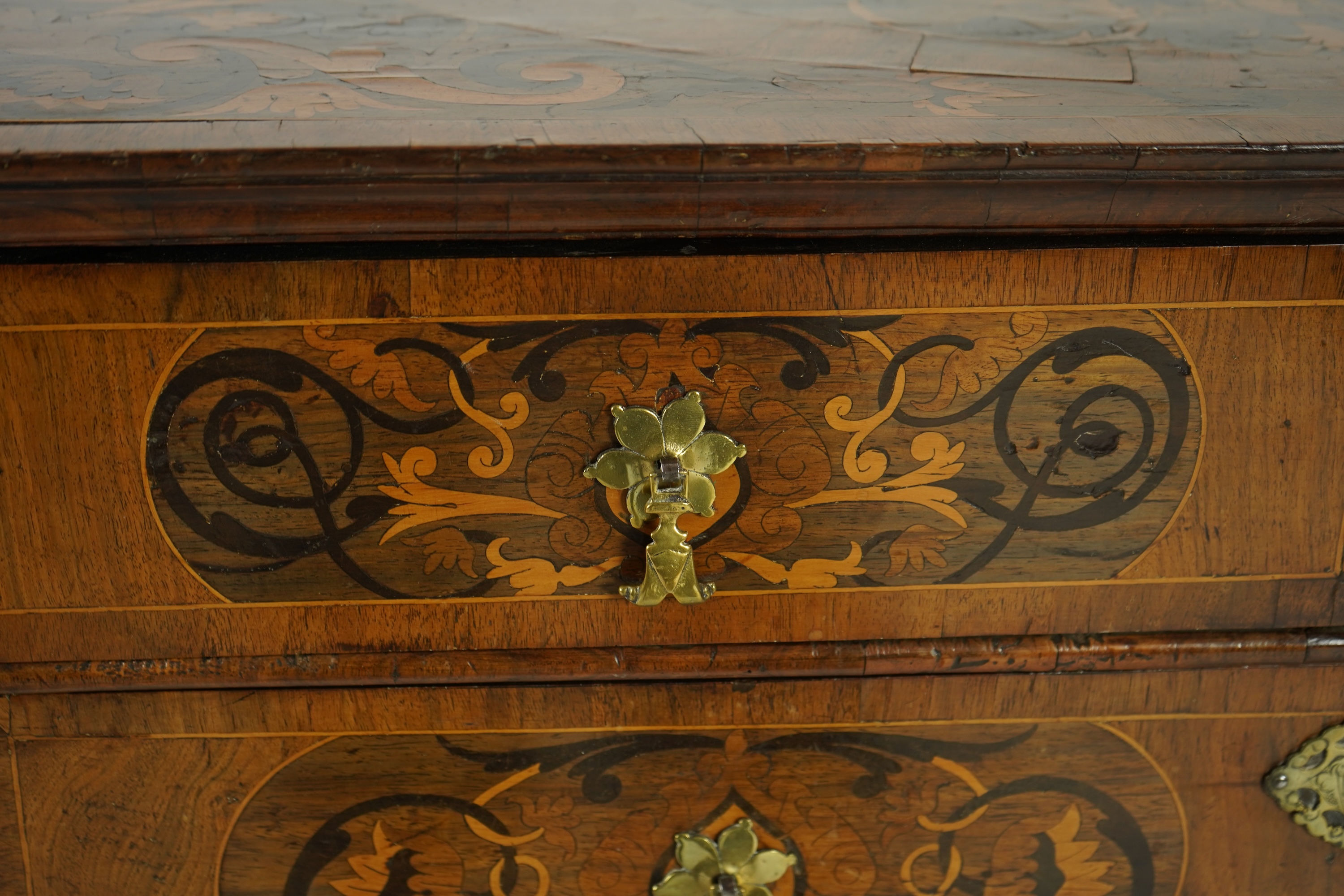 A William and Mary walnut and floral marquetry chest on later bracket feet